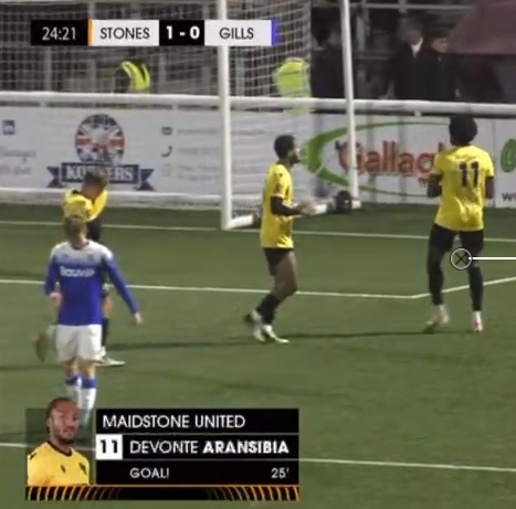 Devonte jumping up after scoring a goal, wearing a yellow t-shirt for Maidstone football club